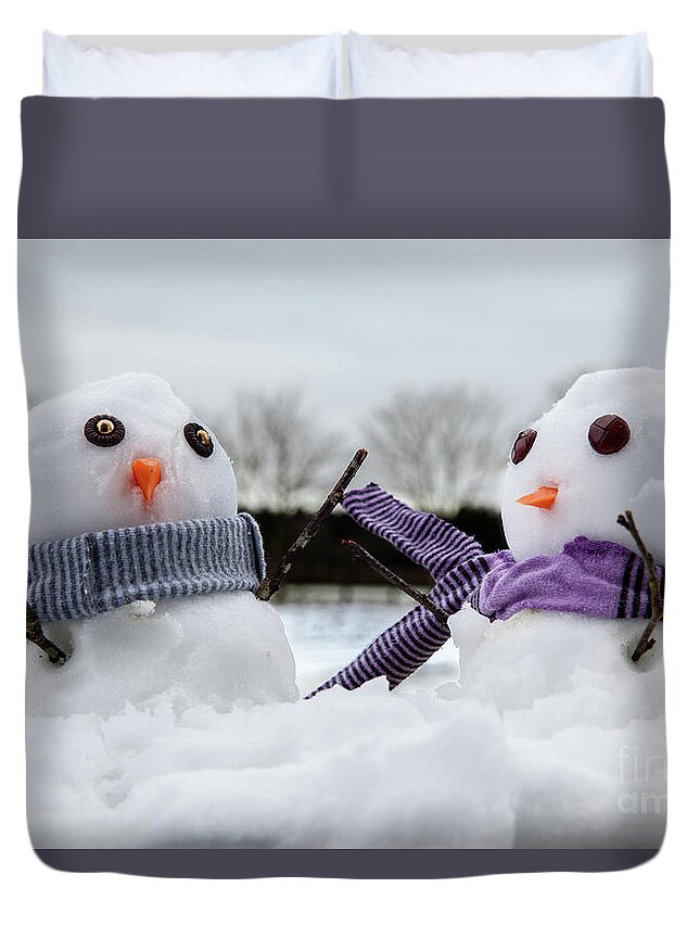 Snowmen Duvet Cover featuring the photograph Two cute snowmen wearing scarfs and twigs for arms by Simon Bratt