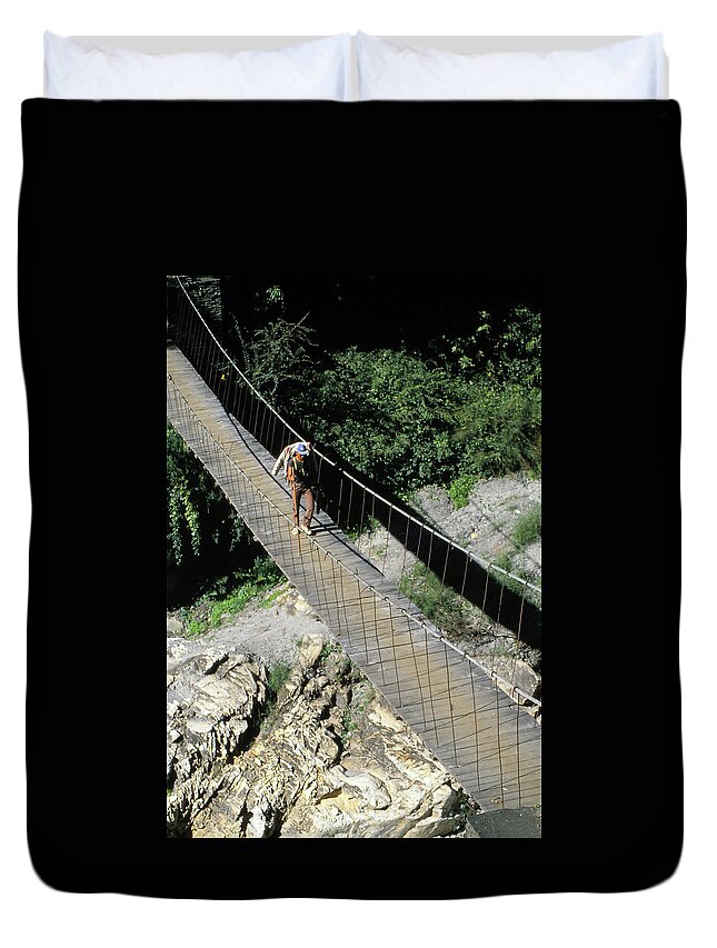 Himal Duvet Cover featuring the photograph Crossing a suspension bridge #1 by Steve Estvanik