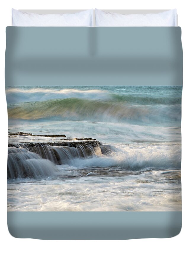 Seascape Duvet Cover featuring the photograph Rocky seashore with wavy ocean and waves crashing on the rocks #1 by Michalakis Ppalis