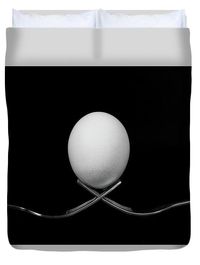 Egg Duvet Cover featuring the photograph White egg resting on two metal and shiny forks on a black backg by Michalakis Ppalis