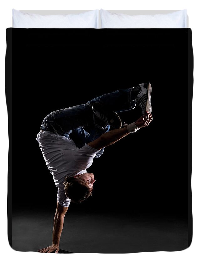 Expertise Duvet Cover featuring the photograph A B-boy Doing A Freeze Breakdance Move by Halfdark