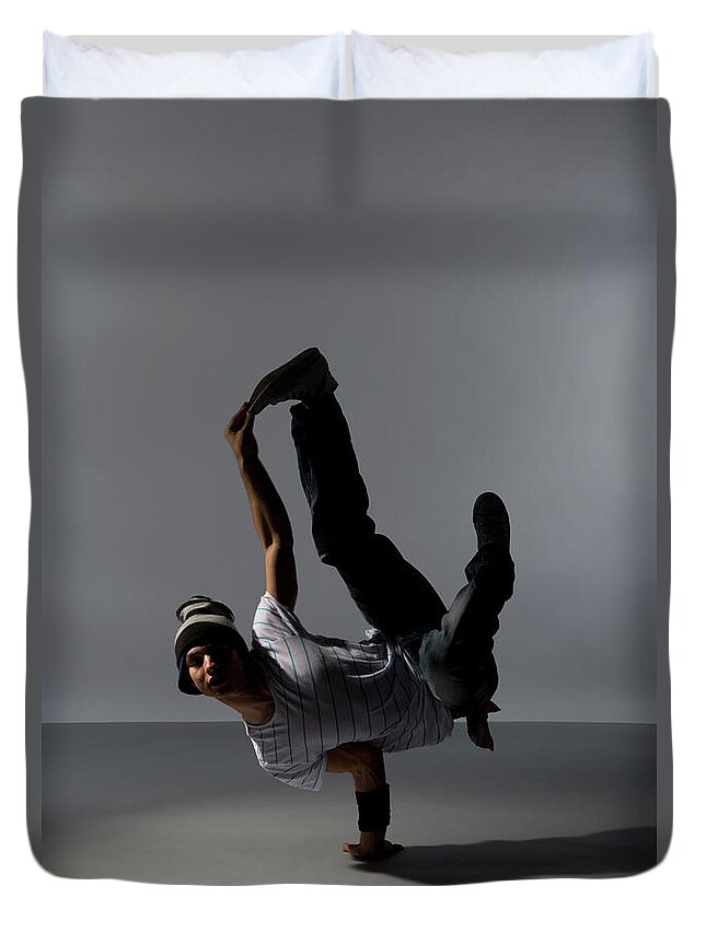 Expertise Duvet Cover featuring the photograph A B-boy Doing A L-kick Breakdance Move by Halfdark