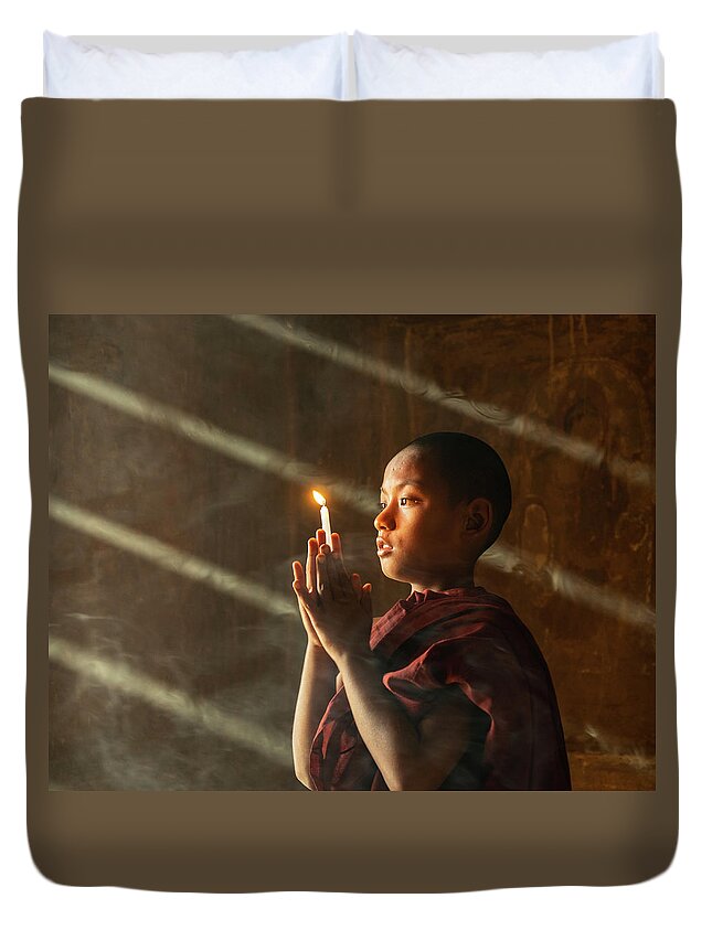 Boy Duvet Cover featuring the photograph A Novice Monk With Candle In Prayer In Temple by Ann Moore