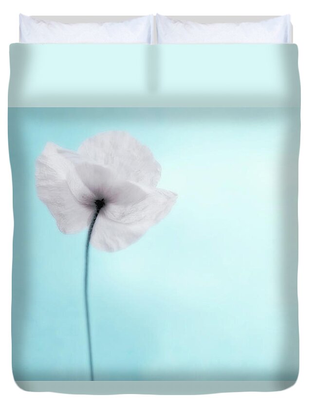 Desaturated Duvet Cover featuring the photograph A Poppy Against A Cool Blue Background by Alexandre Fp