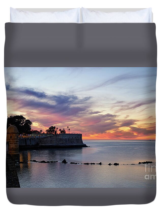 Illumination Duvet Cover featuring the photograph Amazing and Colorful Cloudy Sky at Dusk over Candelaria Bulwark Cadiz by Pablo Avanzini