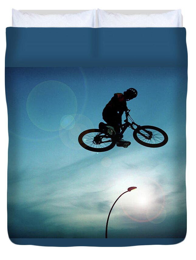 Sports Helmet Duvet Cover featuring the photograph Bicycle Trick Rider by Photostock-israel