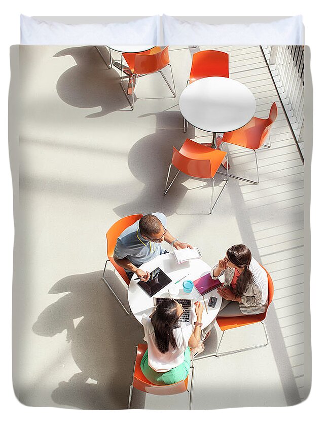 Young Men Duvet Cover featuring the photograph Business People Having Meeting In Cafe by Sydney Roberts