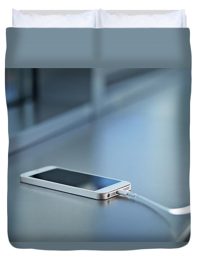 Office Duvet Cover featuring the photograph Close-up Of Smartphone Charging by Klaus Vedfelt