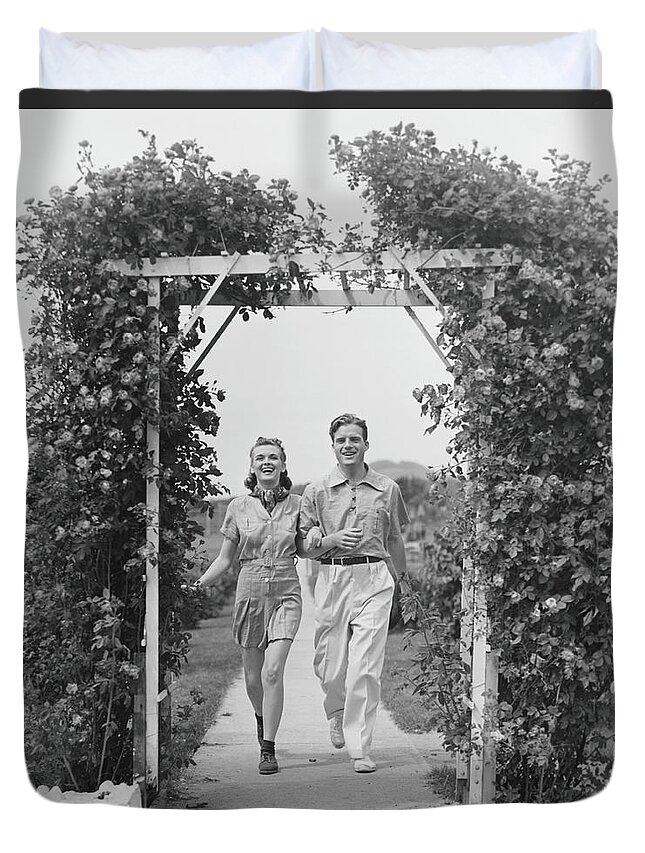 Young Men Duvet Cover featuring the photograph Couple Walking On Footpath Towards Rose by George Marks