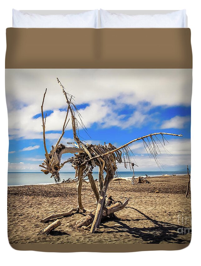 Driftwood Duvet Cover featuring the photograph Driftwood artwork on Hokitika Beach, New Zealand by Lyl Dil Creations