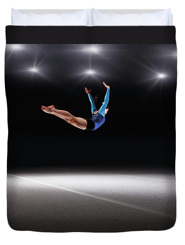 Human Arm Duvet Cover featuring the photograph Female Gymnast Jumping Through Air by Robert Decelis Ltd