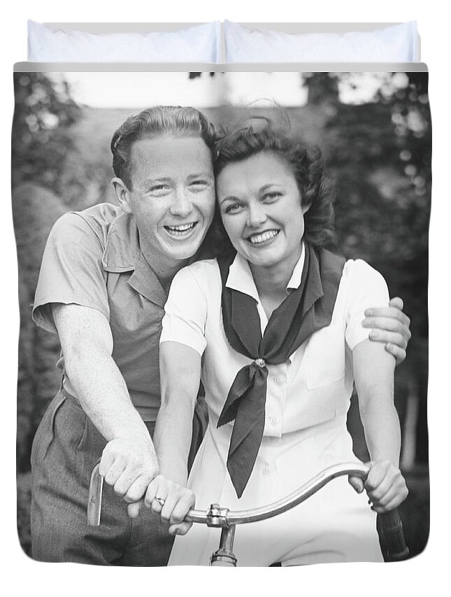 Young Men Duvet Cover featuring the photograph Man Embracing Woman Sitting On Bike by George Marks