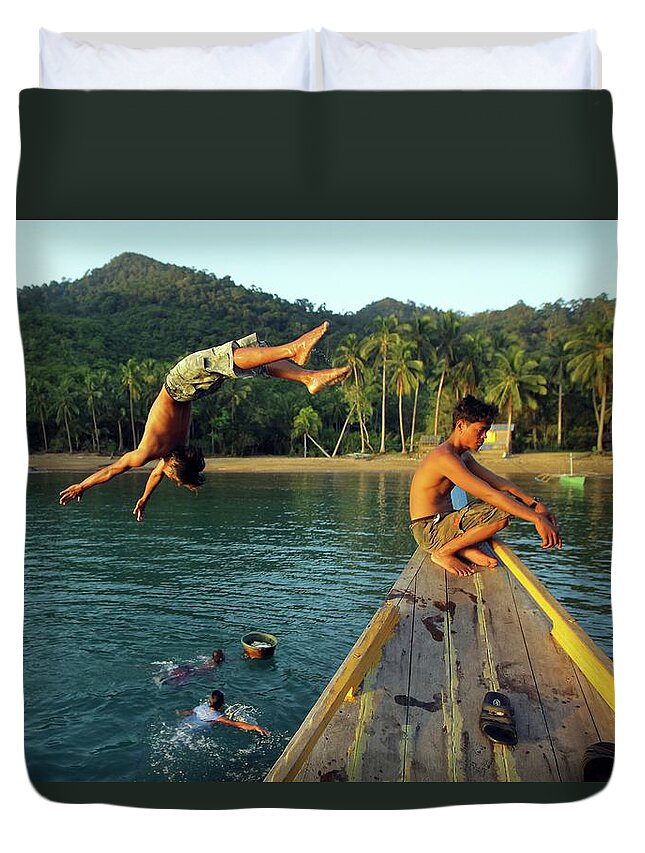 Young Men Duvet Cover featuring the photograph Pa Aling Diver Jumps Into Water By by Timothy Allen