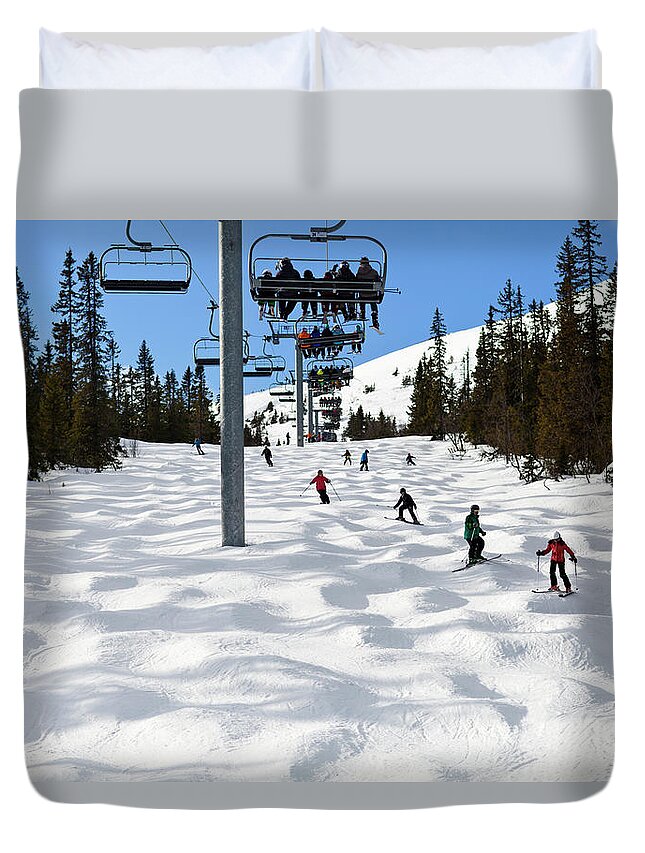 Skiing Duvet Cover featuring the photograph People Skiing Under Ski Lift by Johner Images