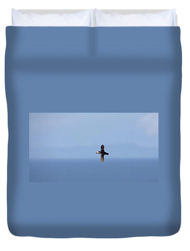 Puffin Duvet Cover featuring the photograph Puffin Flying Over Sea by Pete Walkden