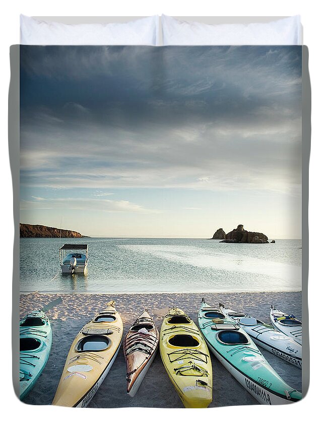 In A Row Duvet Cover featuring the photograph Sea Kayaks Lined Up On Beach by Zia Soleil