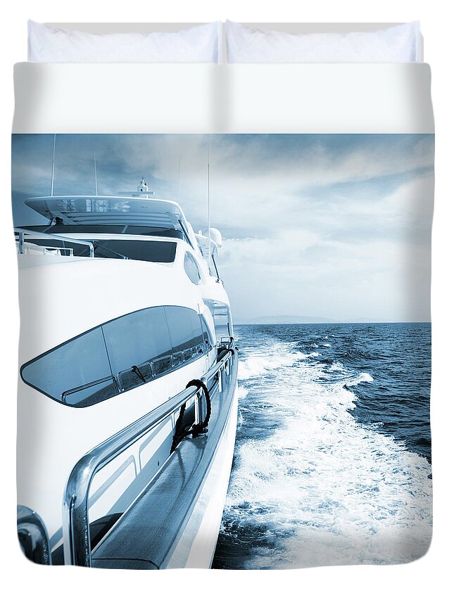 Desaturated Duvet Cover featuring the photograph Side View Of Luxury Yacht Sailing The by Petreplesea