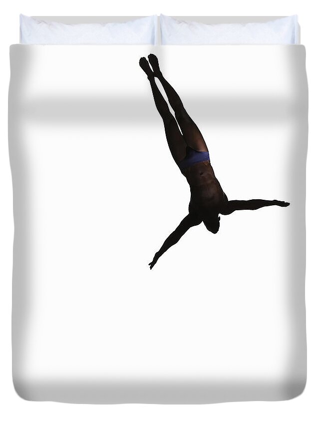 Diving Into Water Duvet Cover featuring the photograph Silhouette Of Man Jumping Off Diving by Paul Taylor