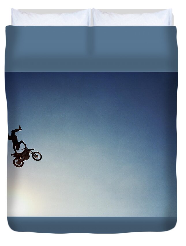 Crash Helmet Duvet Cover featuring the photograph Silhouette Of Man Performing Stunts On by Andy Ryan