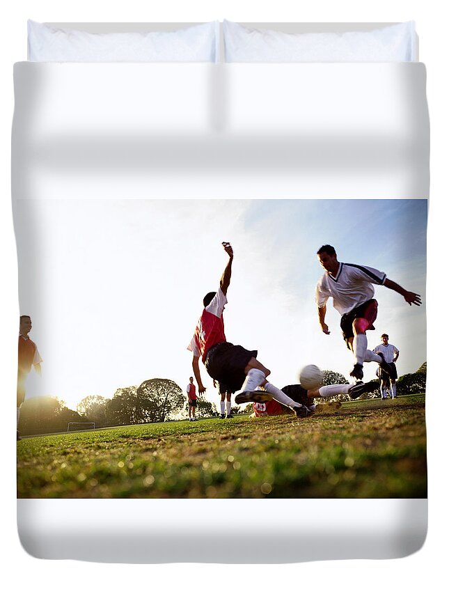 Soccer Uniform Duvet Cover featuring the photograph Soccer Players Tackling For Ball by Ryan Mcvay