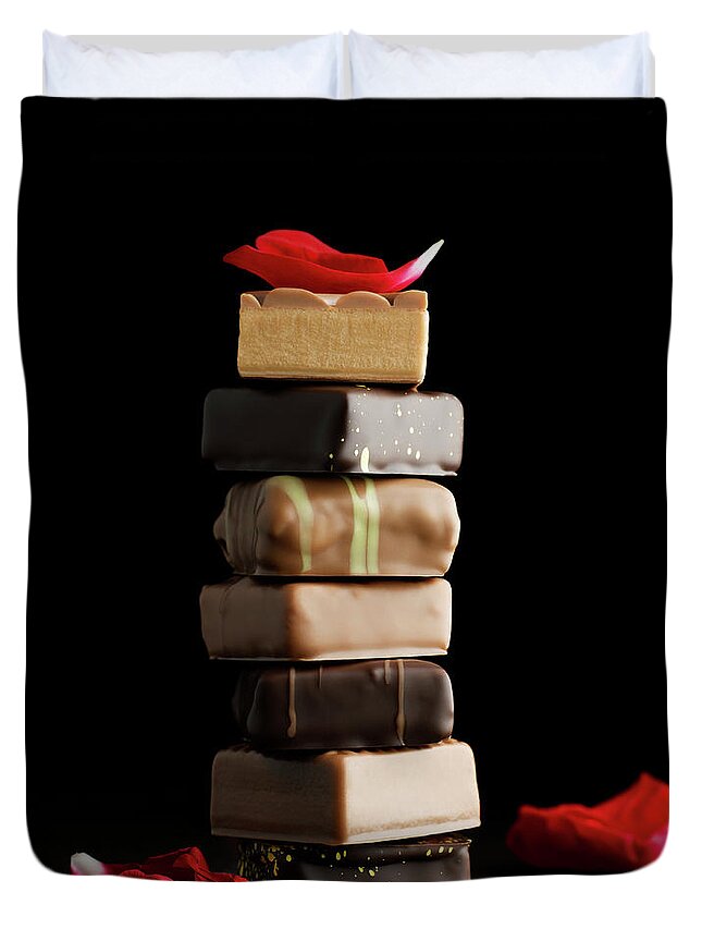 Black Background Duvet Cover featuring the photograph Tower Of Chocolates With Rose Petals On by Sabine Scheckel