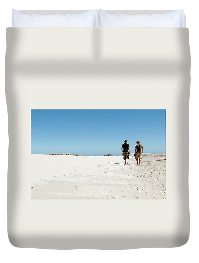 Young Men Duvet Cover featuring the photograph Two Mans Walking Along The Seashore by Casarsa