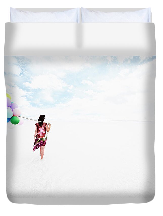 Scenics Duvet Cover featuring the photograph Woman Holding Balloons Walking Through by Thomas Barwick