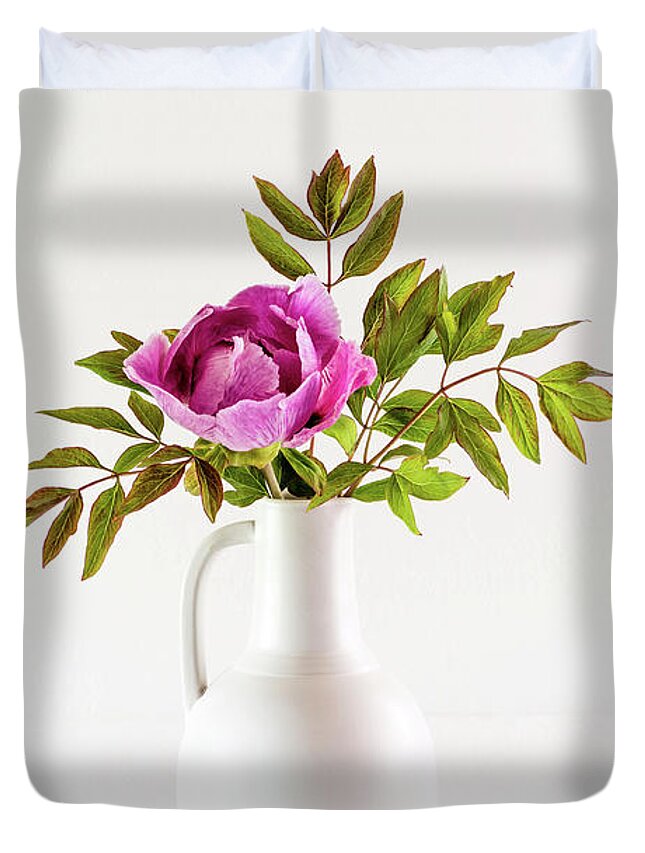 Tree Peony Duvet Cover featuring the photograph Tree peony Lan He Paeonia suffruticosa rockii in a white vase by Torbjorn Swenelius