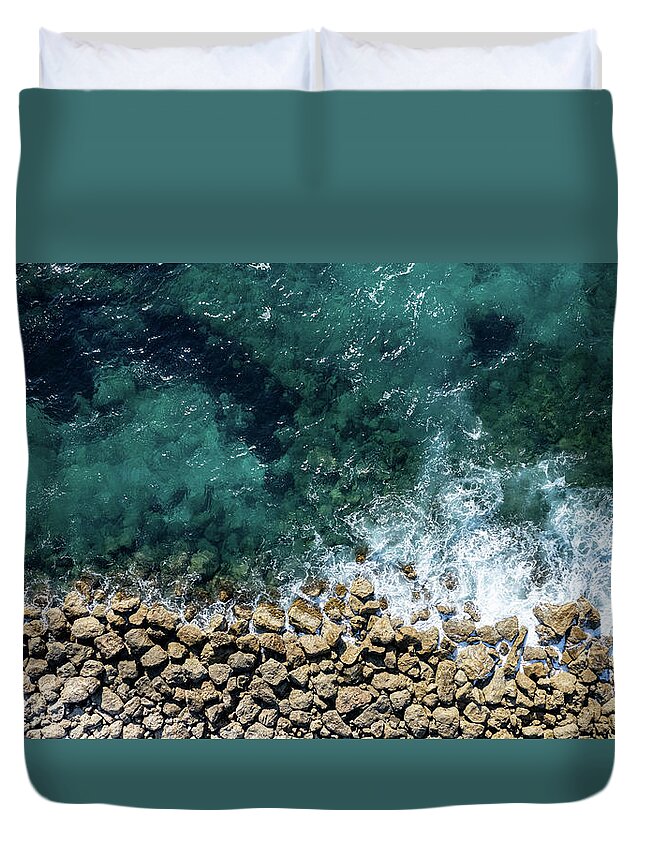 Seascape Duvet Cover featuring the photograph Aerial view from flying drone of crystal blue ocean water and sea wall. by Michalakis Ppalis