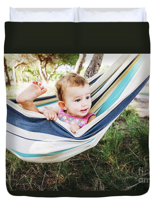Adorable Duvet Cover featuring the photograph Adorable one year old girl inside a hammock smiling and having f by Joaquin Corbalan