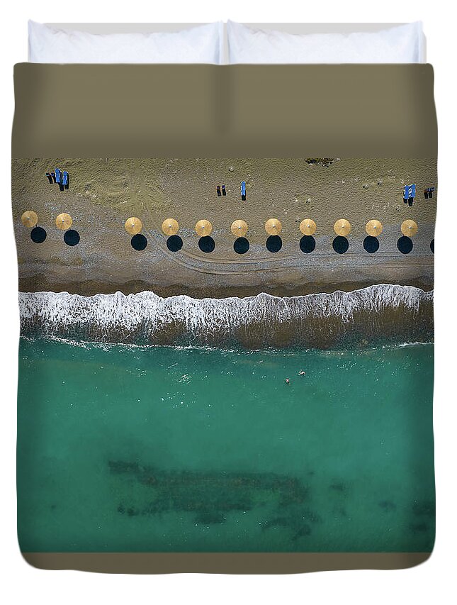  Beach Duvet Cover featuring the photograph Aerial view from a flying drone of beach umbrellas in a row on a by Michalakis Ppalis