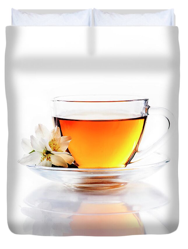 Tea Duvet Cover featuring the photograph Asian green tea with jasmine flower in transparent teacup isolat by Jelena Jovanovic