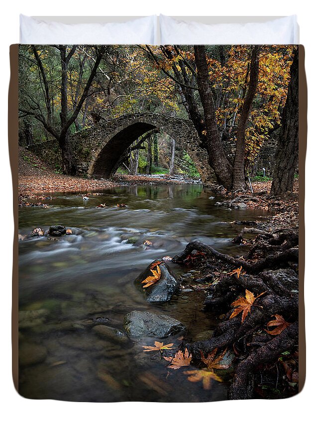 Autumn Duvet Cover featuring the photograph Autumn landscape with river flowing under a stoned bridge by Michalakis Ppalis