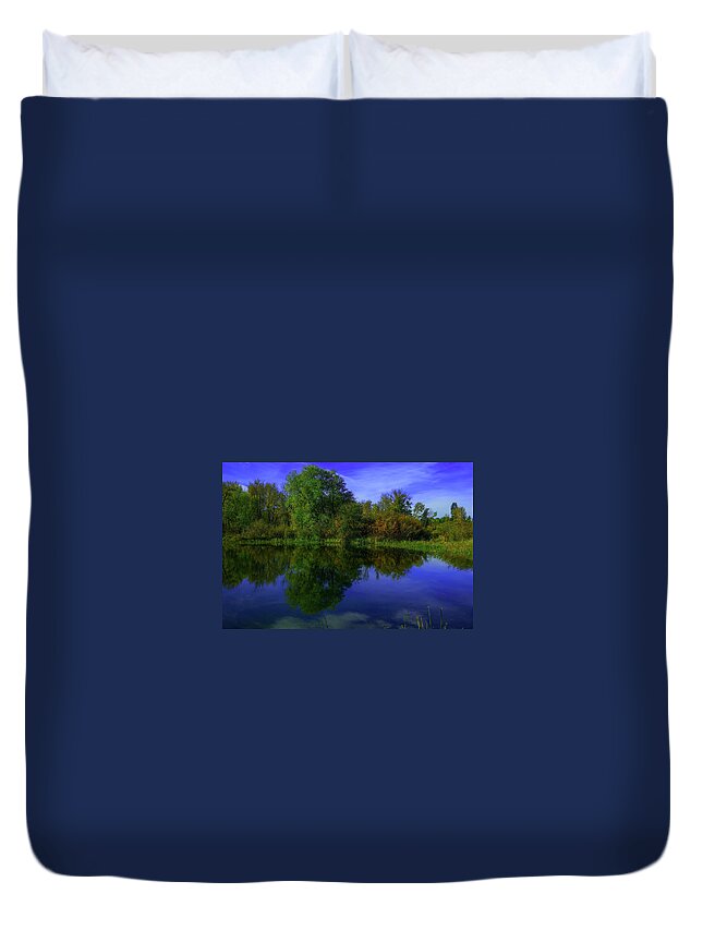 Reflection Duvet Cover featuring the photograph Blue sky and trees reflected in still water by Jeff Swan
