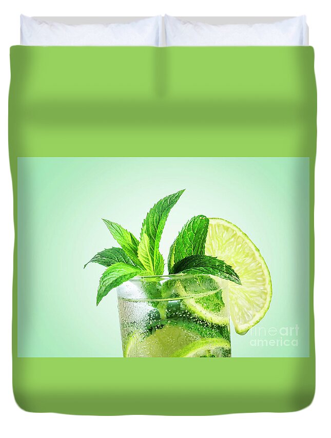 Mojito Duvet Cover featuring the photograph Closeup mojito cocktail with ice isolated over pastel background by Jelena Jovanovic