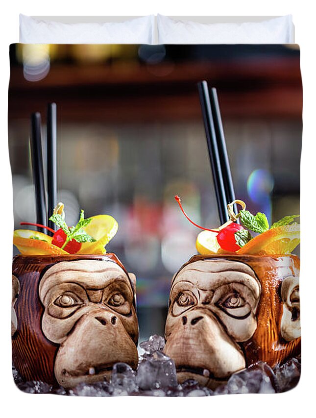 Cocktail Duvet Cover featuring the photograph Coctail in monkey mugs on bar counter by Michal Bednarek
