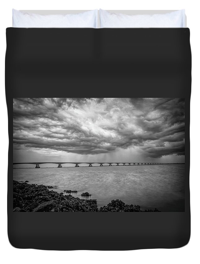 Dark Clouds Duvet Cover featuring the photograph Dark clouds Zeeland Bridge in black and white by Marjolein Van Middelkoop