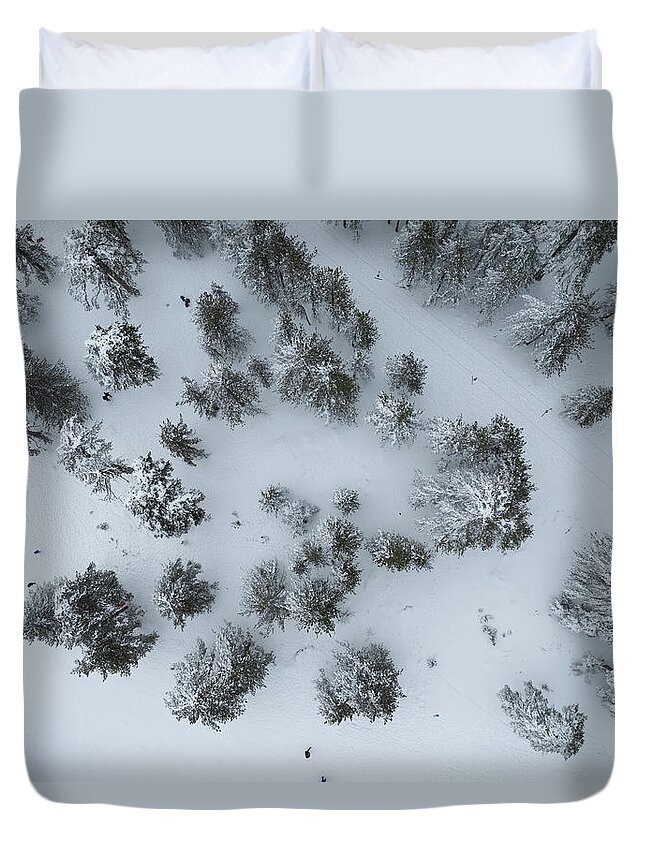Winter Duvet Cover featuring the photograph Drone aerial scenery of mountain snowy forest and people playing in snow. Wintertime season by Michalakis Ppalis