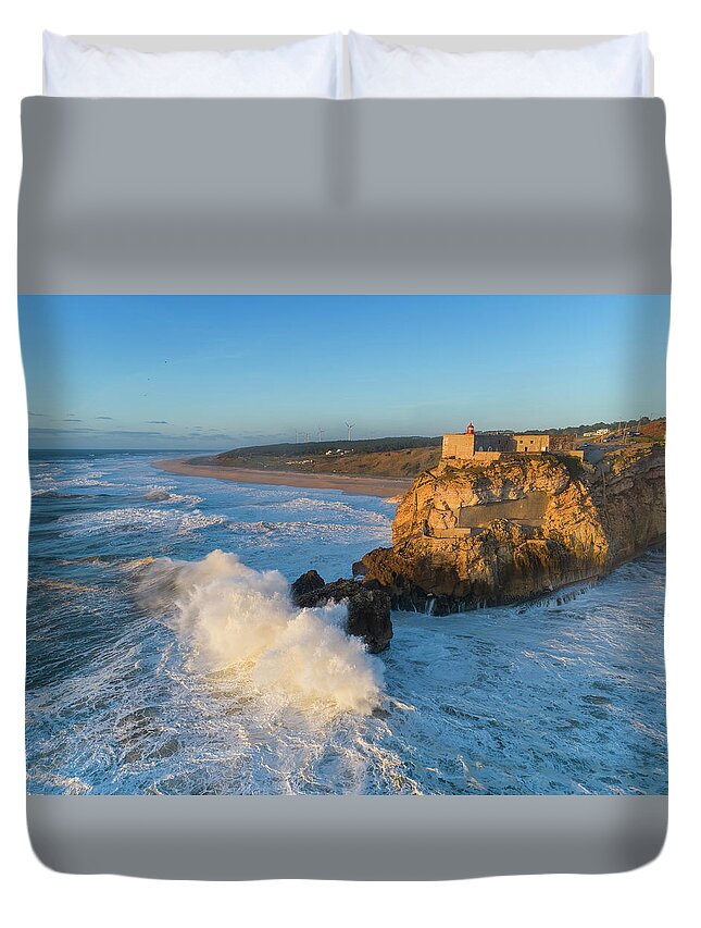 Nazare Duvet Cover featuring the photograph Lighthouse and big waves at in Nazare by Mikhail Kokhanchikov