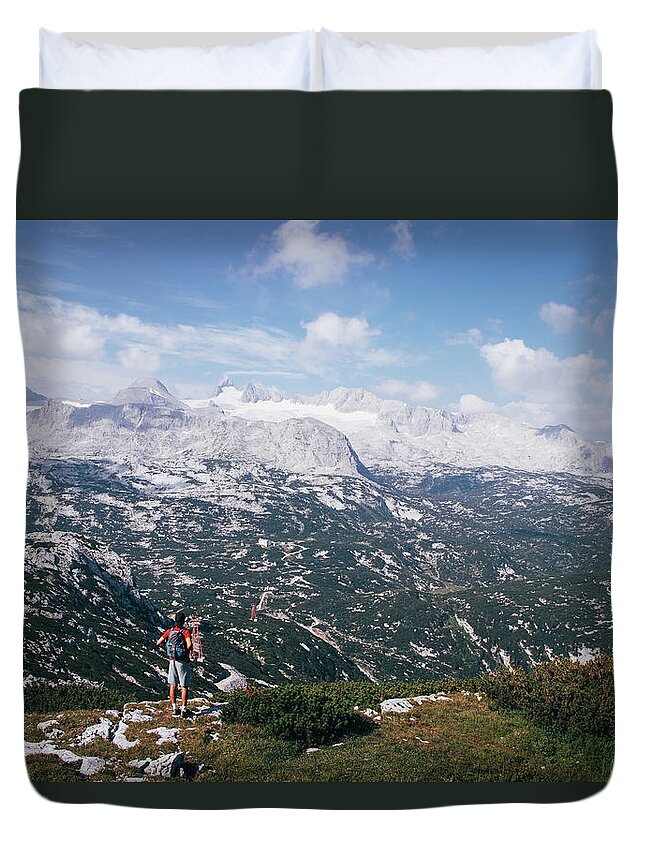 Sportive Duvet Cover featuring the photograph Man with a backpack looks at the Dachstein massif by Vaclav Sonnek