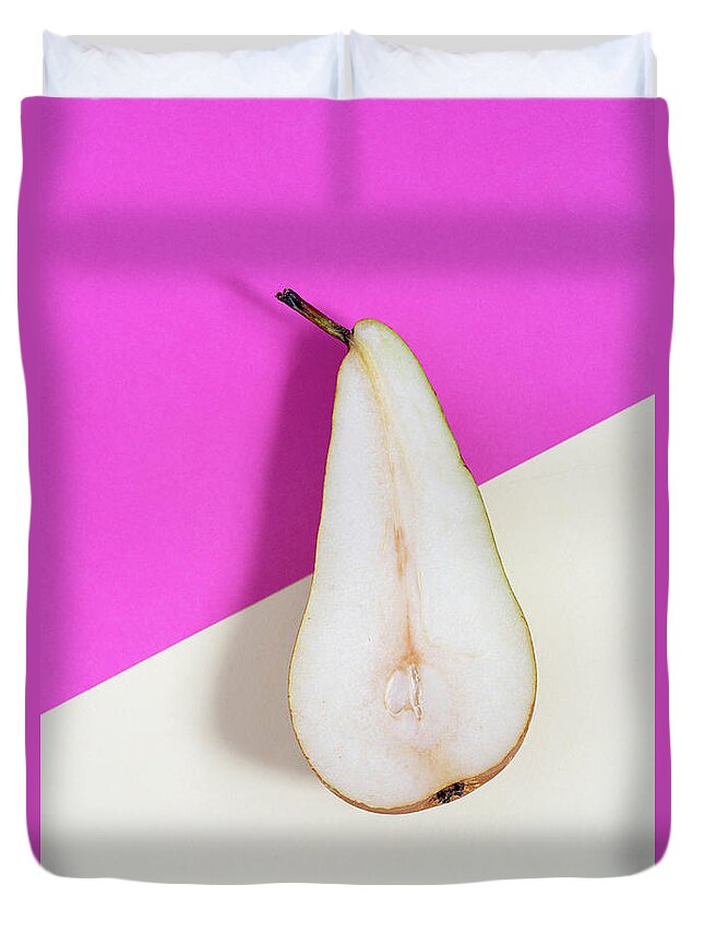 Still-life Duvet Cover featuring the photograph Slice of healthy pear fruit on a colourful background. by Michalakis Ppalis