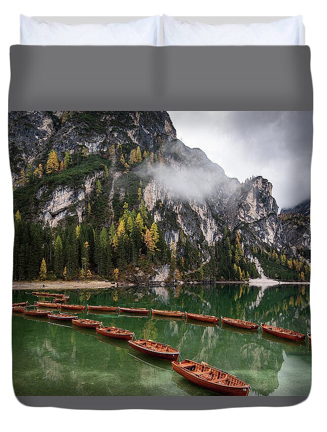 Lago Di Braies Duvet Cover featuring the photograph Wooden boats on the peaceful lake. Lago di braies, Italy by Michalakis Ppalis