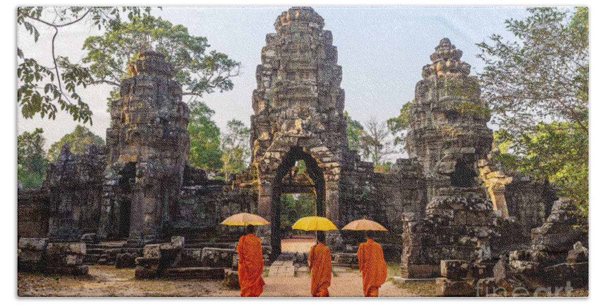 Angkor Hand Towel featuring the photograph Monks with umbrella walking into Angkor Wat temple - Cambodia #1 by Matteo Colombo