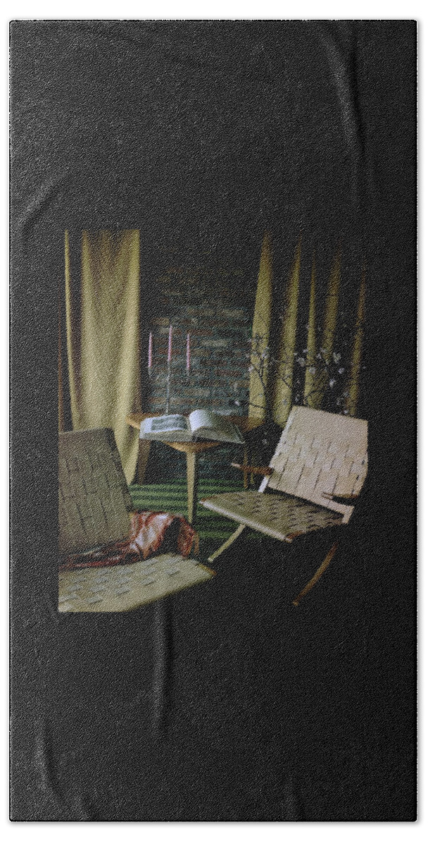 An Armchair Beside A Table And An Old Book Bath Towel