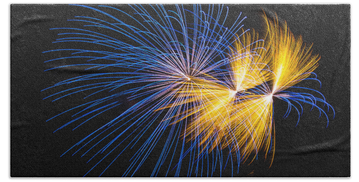 Burst Bath Towel featuring the photograph Blue and Orange fireworks by Paul Freidlund