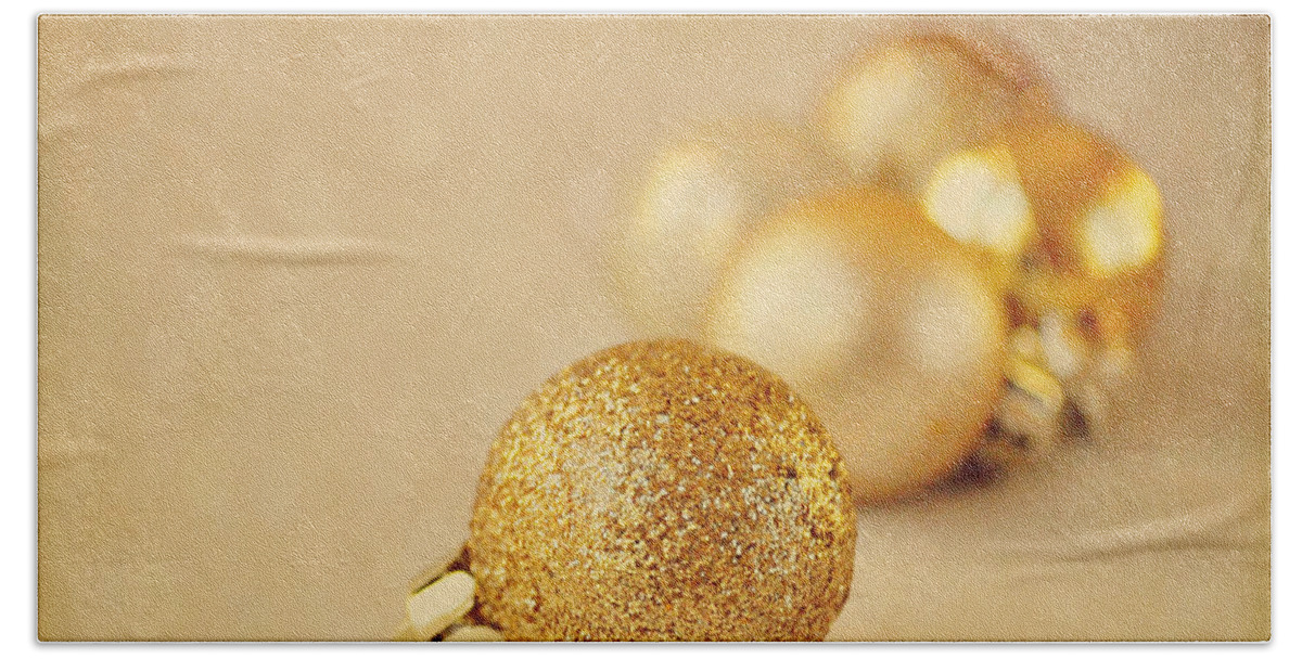 Baubles Hand Towel featuring the photograph Gold glittery Christmas baubles by Lyn Randle