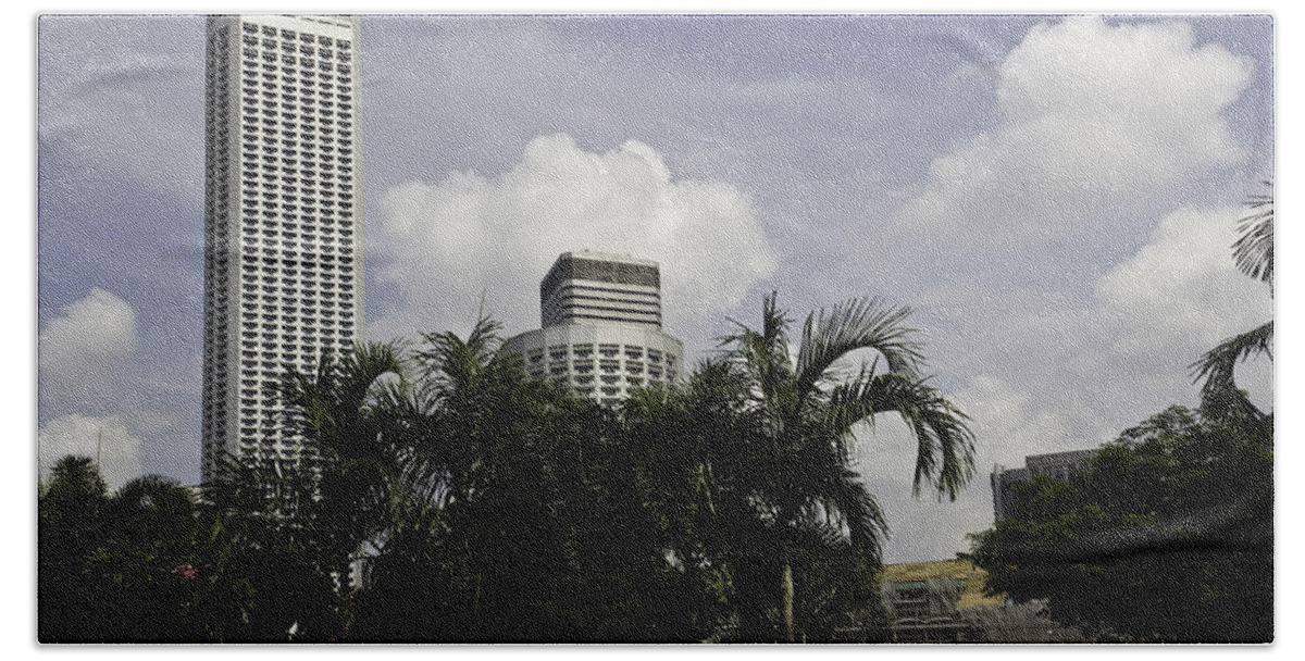Action Bath Towel featuring the photograph High rise buildings behind trees along with construction work in Singapore by Ashish Agarwal
