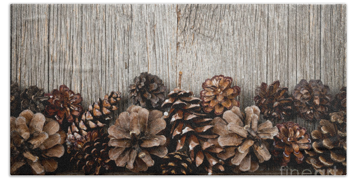Wood Bath Towel featuring the photograph Rustic wood with pine cones by Elena Elisseeva