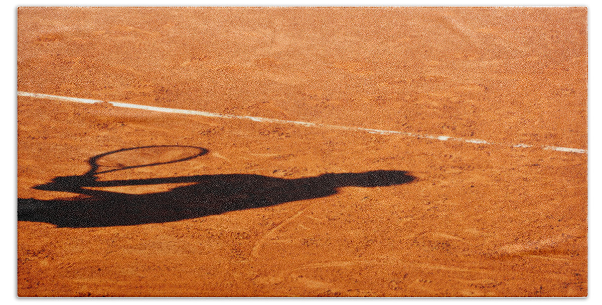 Clay Hand Towel featuring the photograph Tennis player shadow on a clay tennis court by Dutourdumonde Photography