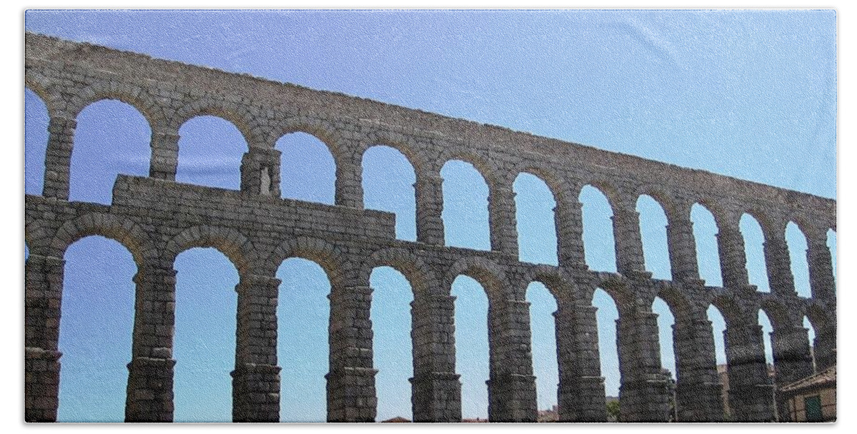 Segovia Bath Towel featuring the photograph Segovia Ancient Roman Aqueduct Architectural Granite Stone Structure IX With Arches in Sky Spain by John Shiron